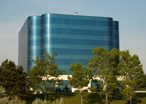 A city office building constructed of blue colored mirror glass.